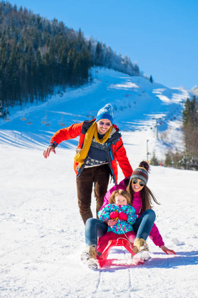 istock Happy Family In Snow Riding On Sledge. 1221501404