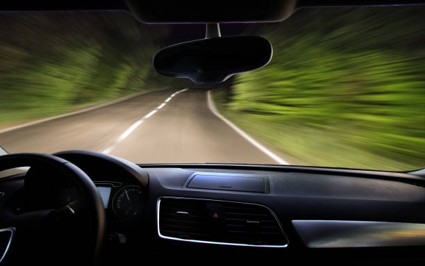 istock view of the night road through the windshield 1221502231
