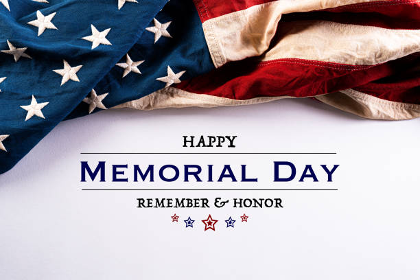 istock Happy Memorial Day. American flags with the text REMEMBER & HONOR against a white background. May 25. 1221503277