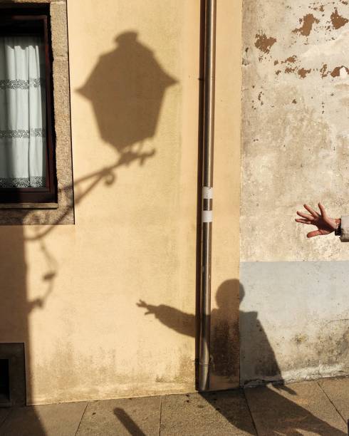 istock A woman’s shadow is waving hi 1221503414