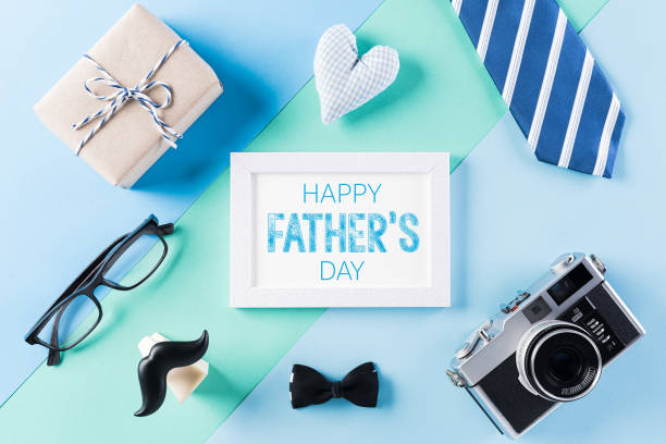 istock Happy Fathers Day background concept with picture frame, retro camera, decorated bowtie, necktie, eyeglasses, gift box and mustache on bright pastel background. 1221503985