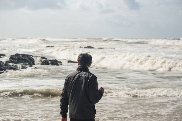 istock A man and the sea waves 1221504046