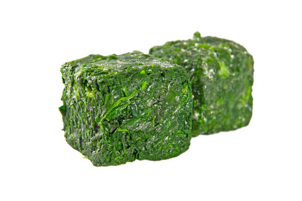 istock a block of frozen spinach isolated on a white background 1221504478