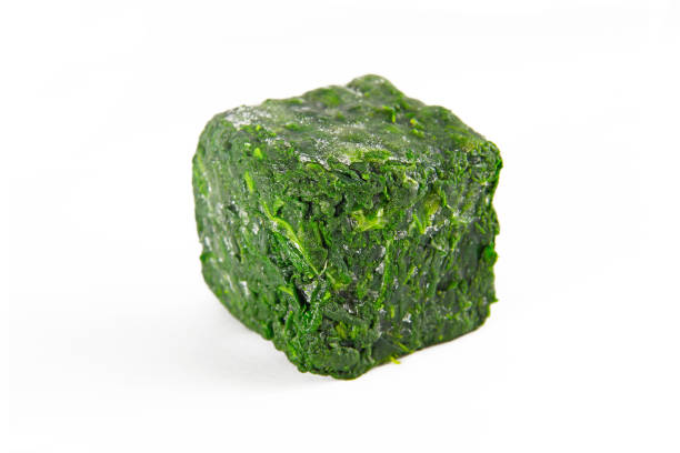 istock a block of frozen spinach isolated on a white background 1221504479