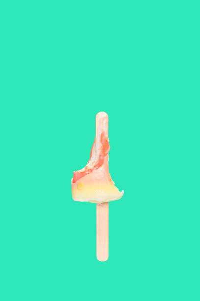istock white chocolate outer popsicle with red inner with the last bit on green background 1221504499