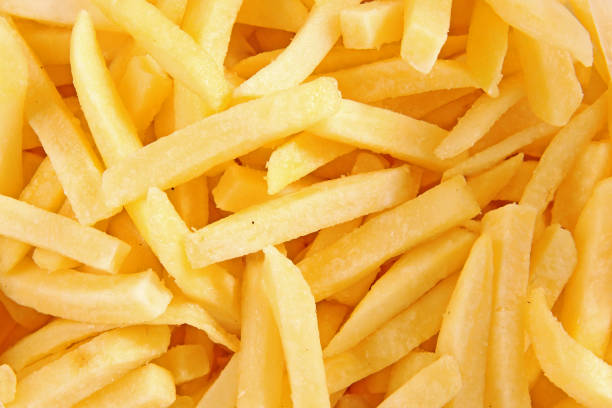 istock fried potato chips - food background 1221505324