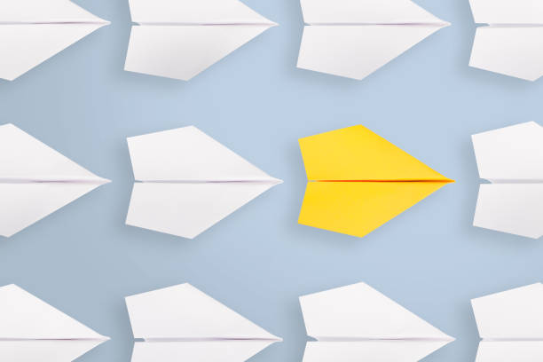 istock Change concepts with yellow paper airplane leading among white 1221507719
