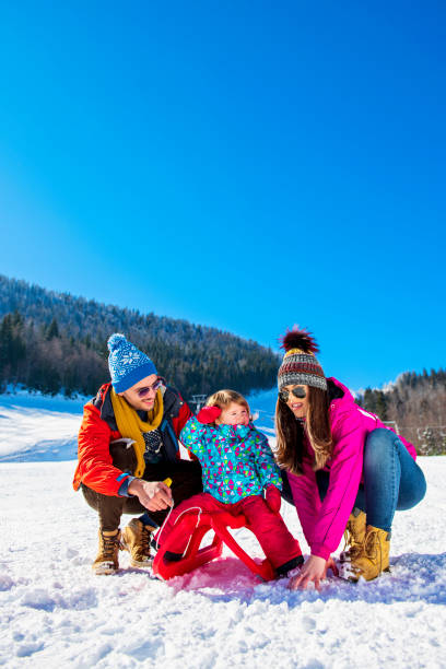 istock Happy Family In Snow Riding On Sledge. 1221509720
