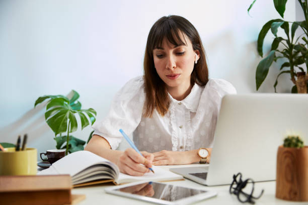 istock Young woman talking on computer in she's home office 1221511264