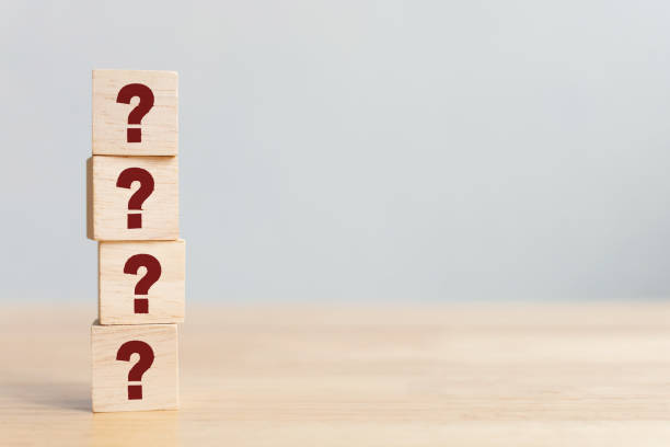istock Wooden cube block shape with sign question mark symbol on wood table 1221512003