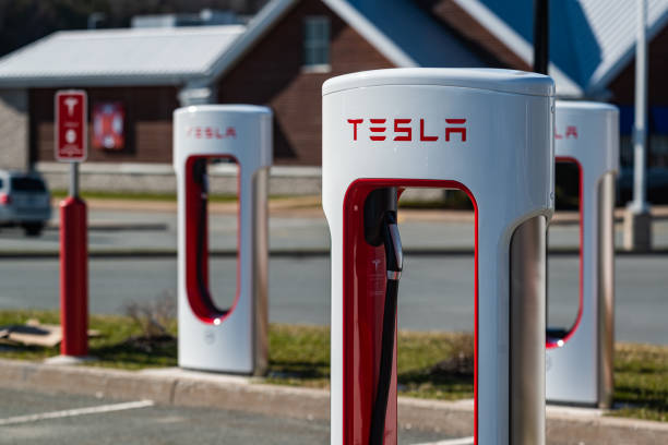 Tesla Supercharger Station April 25, 2020 - Enfield, Canada - Tesla Supercharger station and parking located at an Irving Big Stop gas station on Nova Scotia's Highway 102. tesla model x stock pictures, royalty-free photos & images