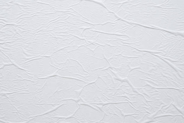 istock Blank white crumpled and creased paper poster texture background 1221516530
