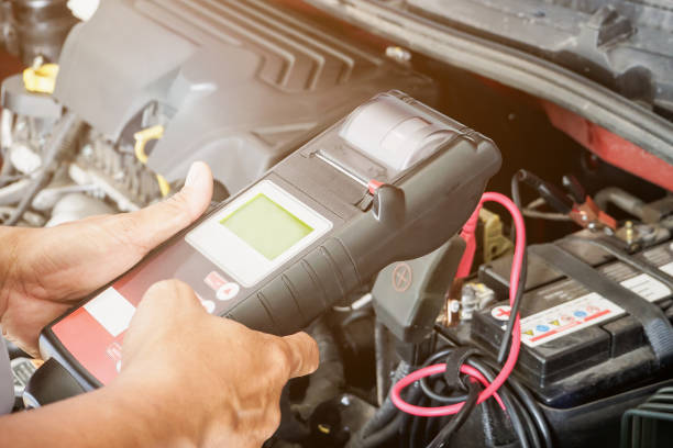 istock mechanic use voltmeter checking voltage of car battery in car service centre 1221516580