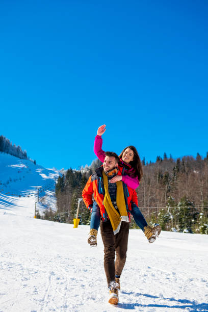 istock happy couple having fun over winter background 1221518520