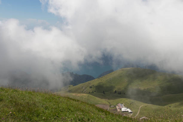 Mountain landscape. Rainy clouds above mountains with lake on background.