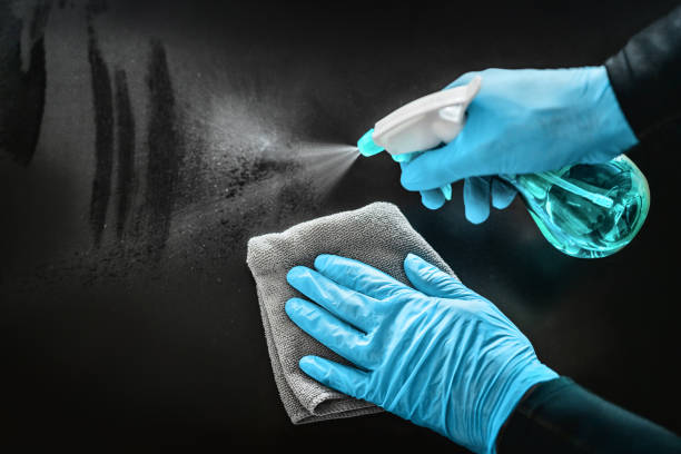 Surface cleaning disinfecting home with sanitizing antibacterial wipes protection against COVID-19 spreading wearing medical blue gloves. Sanitize surfaces prevention in hospitals and public spaces