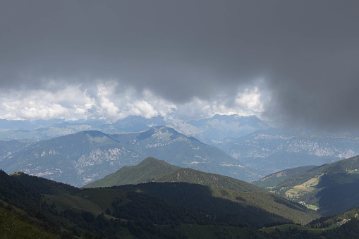 Mountain landscape. Thick rainy clouds above mountains.