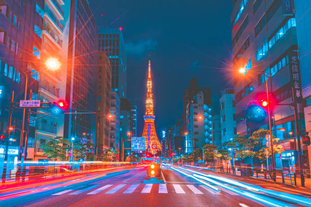 Tokyo Tower spotlit dusk overlooking zooming traffic city streets Japan Tokyo Tower spotlit dusk overlooking zooming traffic city streets Japan tokyo prefecture tokyo tower japan night stock pictures, royalty-free photos & images