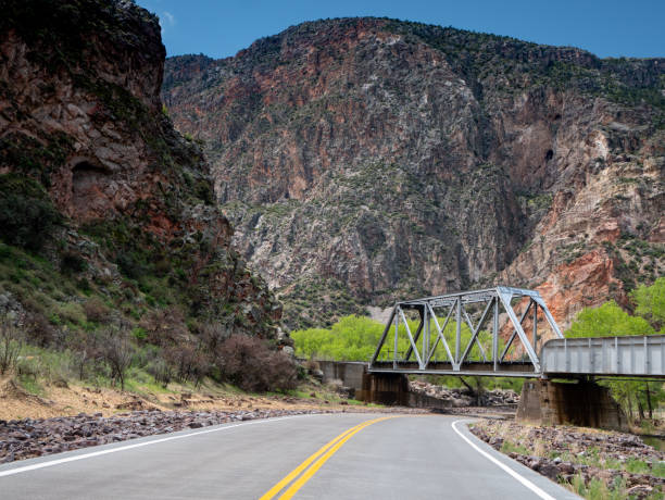 istock Railroad bridge over roadway and towering cliffs in Rainbow Canyon, Nevada 1221521505