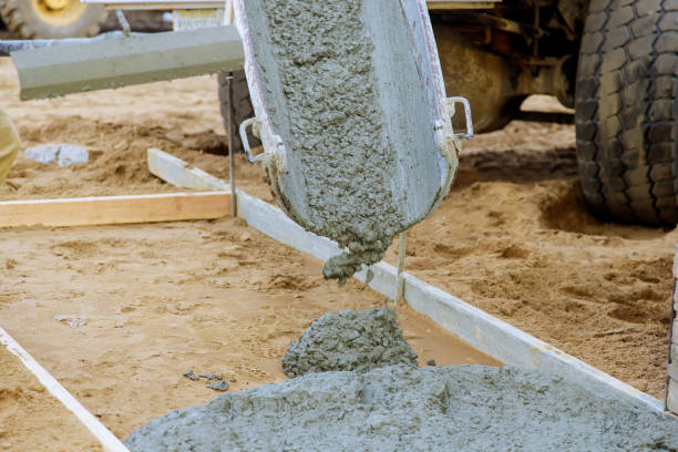 istock Construction workers mixer truck cement during pouring sidewalk 1221522240