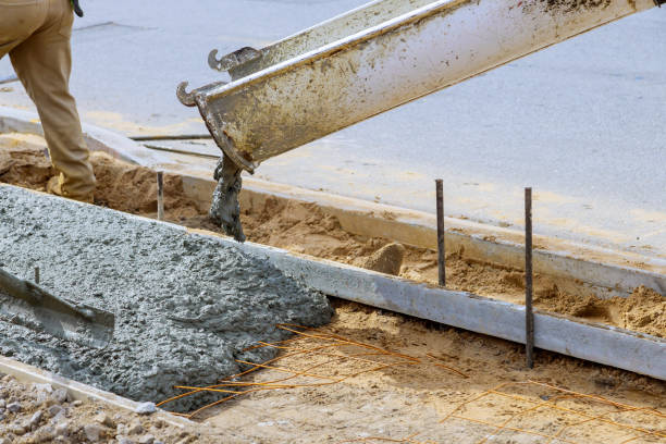 istock Industrial workers pouring fresh concrete in reinforced cement sidewalk 1221522242