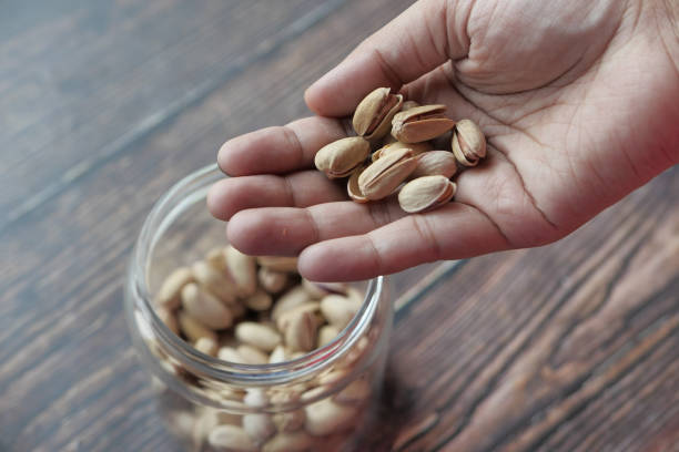 istock high angle view of pistachios nut on hand 1221524521