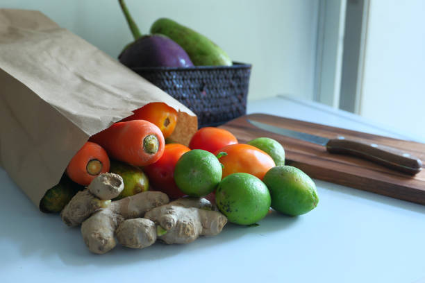 istock fresh vegetable in a shopping bag and knife on table 1221525115