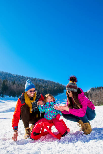 istock Happy Family In Snow Riding On Sledge. 1221525238