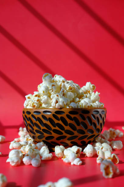 色の背景にボウルのポップコーンの高角度ビュー - popcorn snack bowl corn ストックフォトと画像