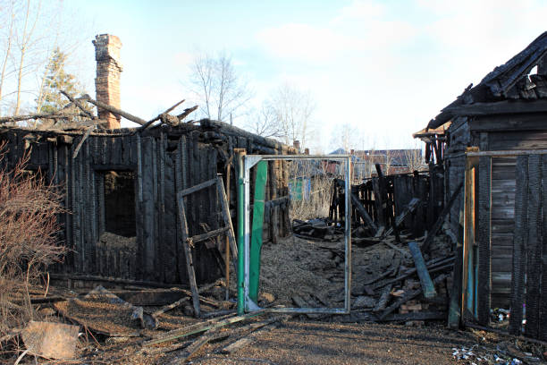 istock After fire - burnt house. Black burned wooden walls 1221528209
