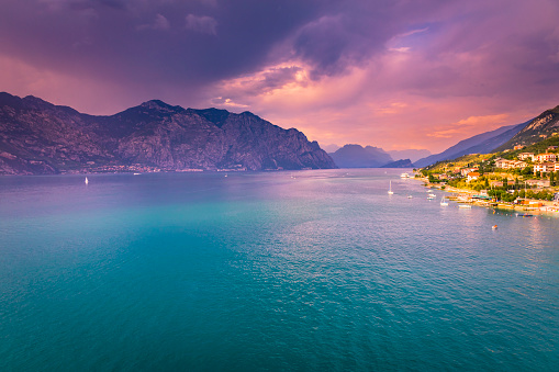 Turquoise Lake Garda and sailboats from above at sunset – Malcesine, Lombardy, Italy