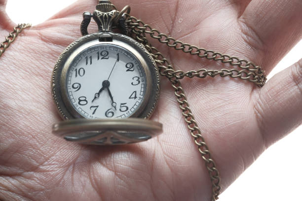 istock Close up of old clock on hand, deadline concept 1221530313