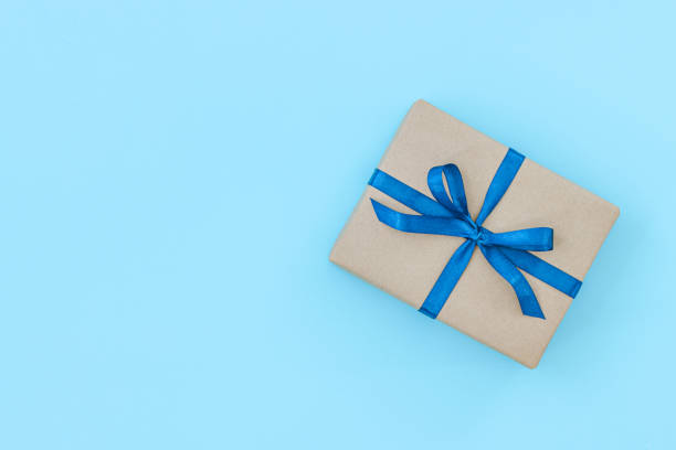 istock Present box package in craft paper over white background. Top view, 1221532445
