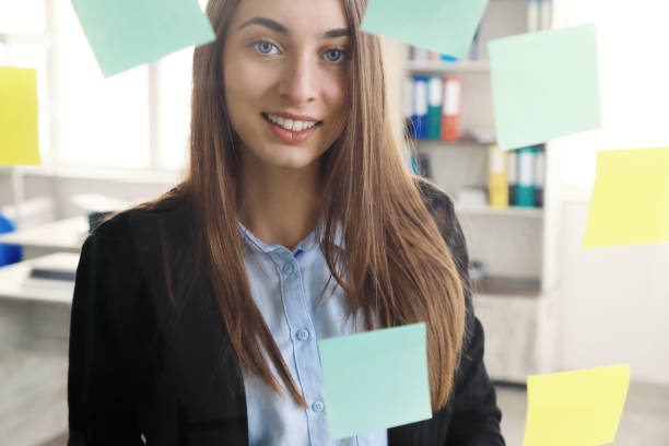 istock Beautiful business woman looking at sticky notes 1221534773