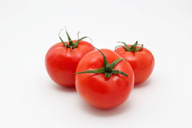istock Bunch of ripe tomatoes isolated on white background 1221534992