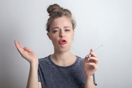 Young Caucasian Woman Girl Doesnt Like Smoking A Cigarette Funny Disgusted  Face Stock Photo - Download Image Now - iStock