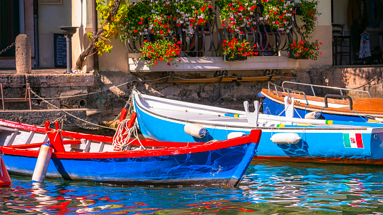 Colorful Boats on Limone Sul Garda pier - Lake Garda , Italy