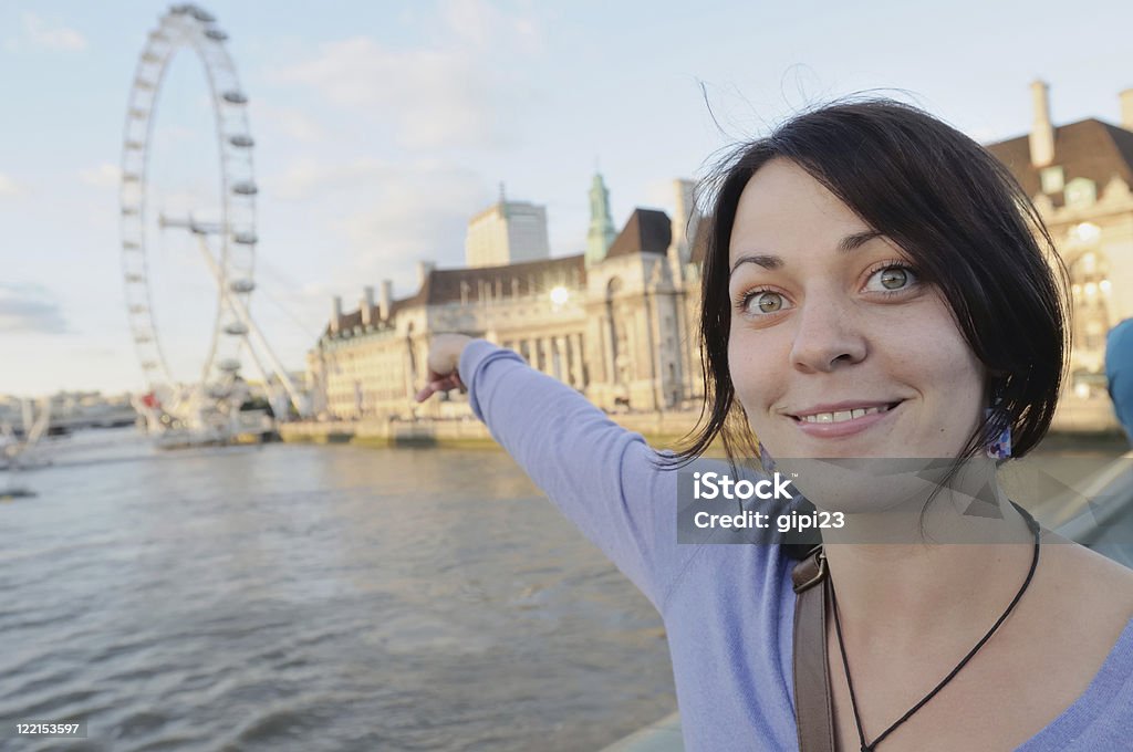 Here it is Happy female tourist pointing at the London Eye, London. 20-29 Years Stock Photo