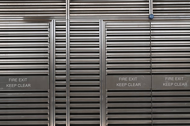 Fire exit Metal gate - fire exit, keep clear. emergency exit photos stock pictures, royalty-free photos & images