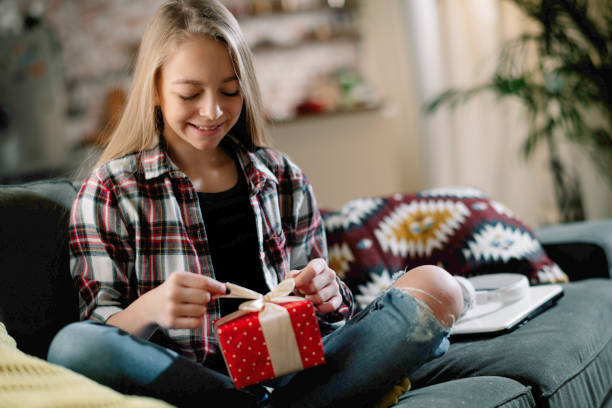 istock Young little girl giving a present. 1221537027