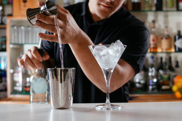 istock Expert barman making cocktail at nightclub. 1221537148