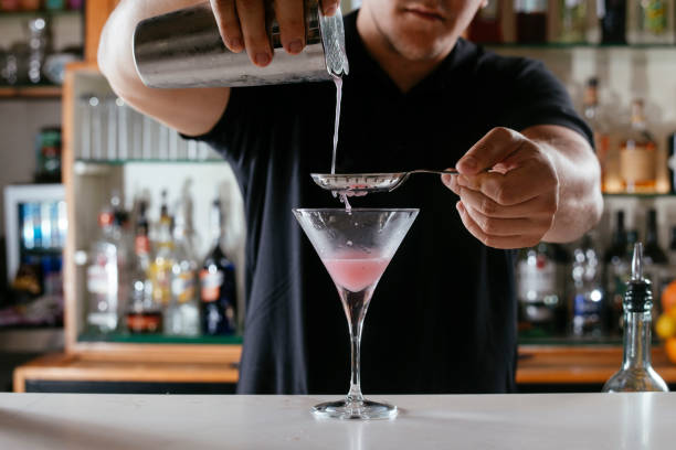 istock Expert barman making cocktail at nightclub. 1221537150