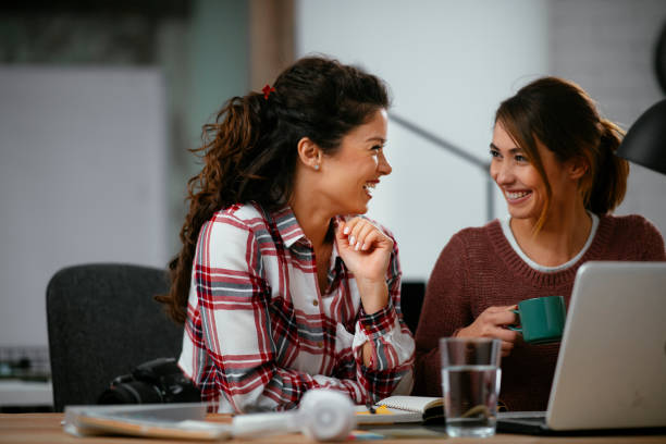 istock Beautiful young girls having fun in office. 1221537809