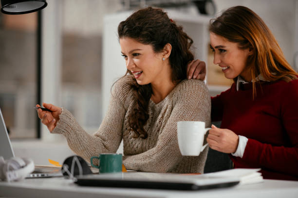 istock Beautiful young girls having fun in office. 1221537869