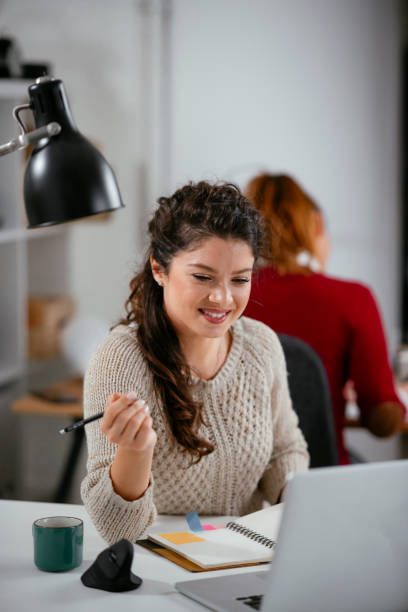 istock Beautiful businesswoman working on lap top. 1221537908