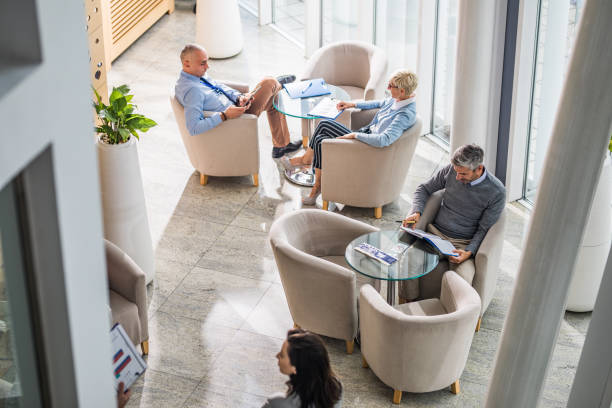 istock Above view of multi-tasking business colleagues working in a hallway. 1221538139