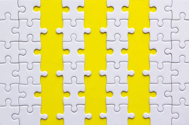 istock Jigsaw puzzle white color on yellow background,Row puzzle pieces grid,Success mosaic solution template 1221540094