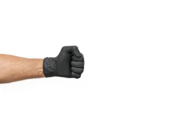 istock Men's hand in a disposable black glove 1221543422