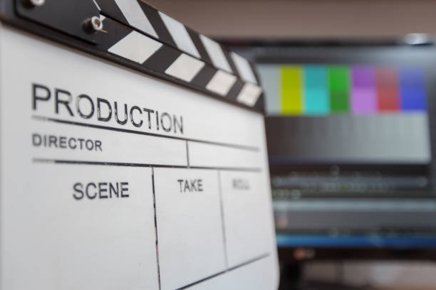 istock Movie clapper and editing room in background 1221546769