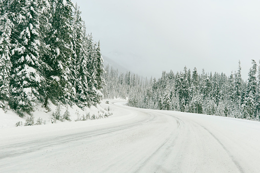 A car travelling down a snowy road in British Columbia, Canada.